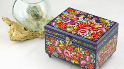 A small square jewelry box with Petrikov painting